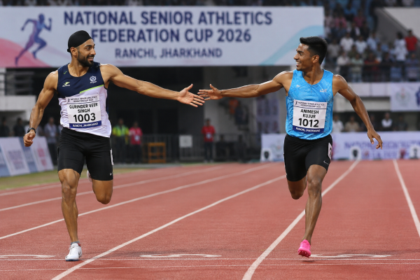 Sprinters Gurinder Veer Singh and Animesh Kujur demonstrate the spirit of sportsmanship while racing on the 100-meter track during the National Senior Athletics Federation Cup in Ranchi.