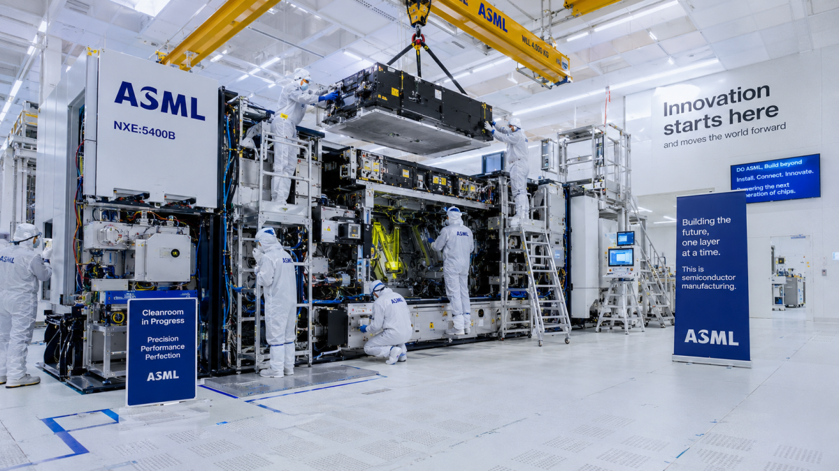 Cleanroom workers installing highly advanced ASML photolithography manufacturing equipment inside a multi-billion dollar semiconductor fabrication facility.