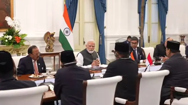 PM Narendra Modi and Indonesian President Prabowo Subianto shaking hands during bilateral talks in a decorated state room.