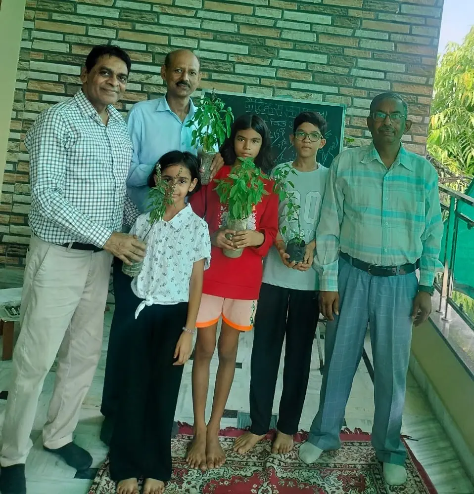 कारगिल युद्ध प्रतियोगिता में पुरस्कृत बच्चे अवनी, सुयश और तेजस्वनी पौधे प्राप्त करते हुए।